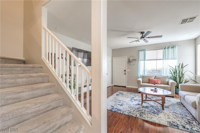 5593 Gold Mint Ln, Las Vegas, NV 89122 - living room featuring stairs, wood finished floors, ceiling fan, baseboards, and visible vents