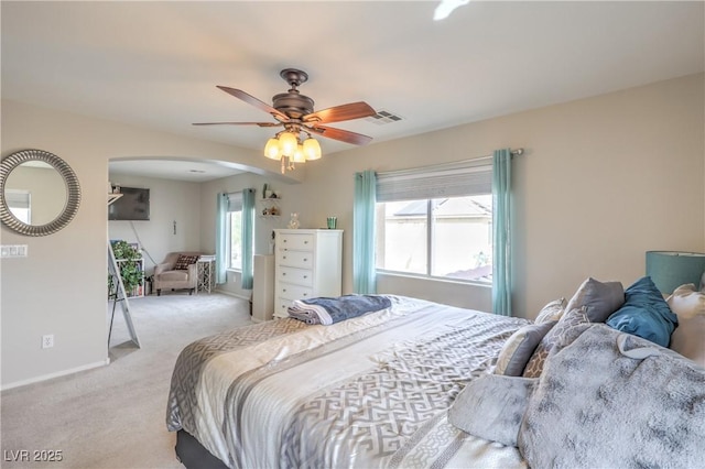 5593 Gold Mint Ln, Las Vegas, NV 89122 - bedroom with visible vents, a ceiling fan, light carpet, arched walkways, and baseboards