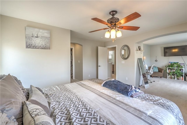 5593 Gold Mint Ln, Las Vegas, NV 89122 - carpeted bedroom featuring arched walkways and a ceiling fan