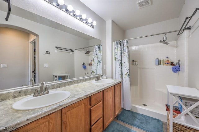 5593 Gold Mint Ln, Las Vegas, NV 89122 - full bath featuring a shower with shower curtain, a sink, visible vents, and double vanity
