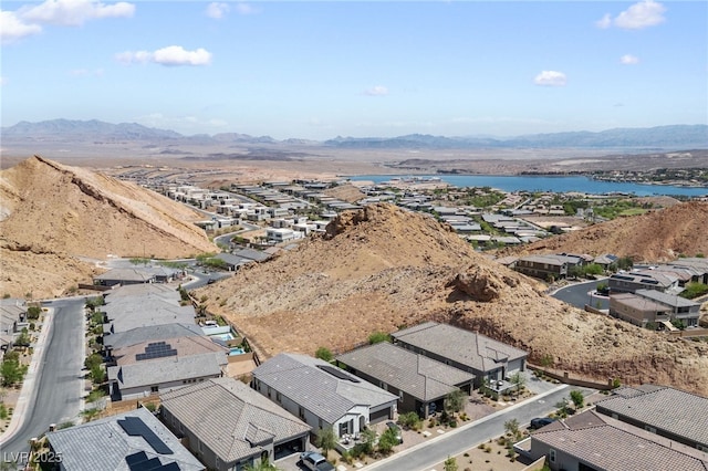 birds eye view of property with a water and mountain view and a residential view