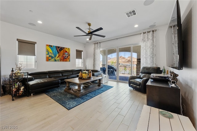 living area with visible vents, a ceiling fan, wood finished floors, and recessed lighting