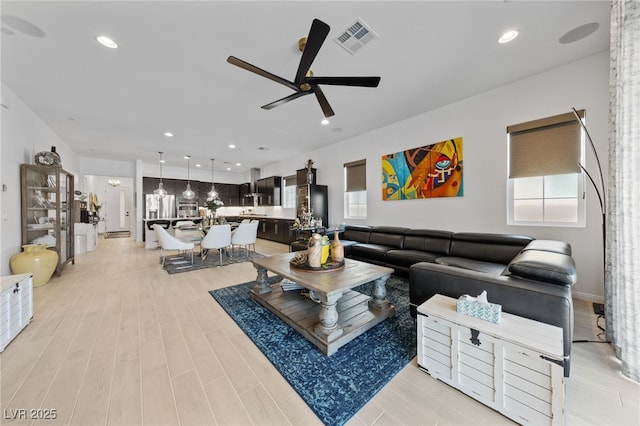 12 Tatahatso Point St, Henderson, NV 89011 - living area featuring ceiling fan, plenty of natural light, light wood finished floors, and recessed lighting
