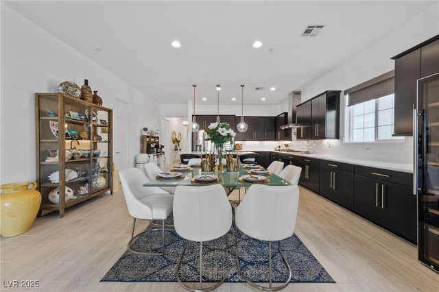 dining area with recessed lighting and light wood-type flooring