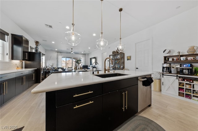 12 Tatahatso Point St, Henderson, NV 89011 - kitchen featuring a sink, stainless steel dishwasher, light countertops, light wood-style flooring, and recessed lighting