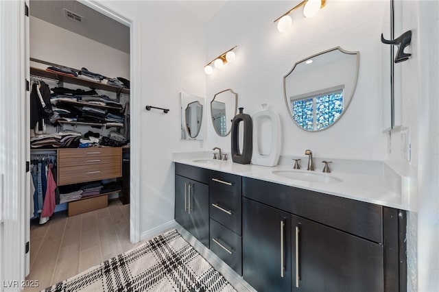 12 Tatahatso Point St, Henderson, NV 89011 - full bathroom featuring double vanity, a spacious closet, and baseboards