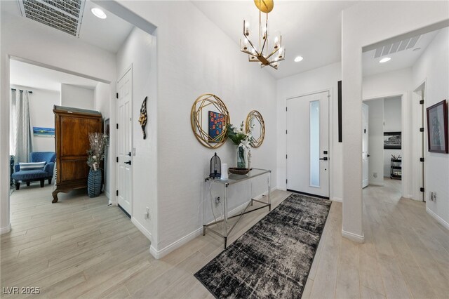 12 Tatahatso Point St, Henderson, NV 89011 - entrance foyer with a chandelier, light wood-style floors, baseboards, and recessed lighting