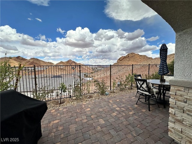 view of patio / terrace featuring fence, outdoor dining area, and a grill