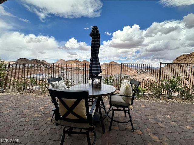 view of patio featuring fence and outdoor dining area