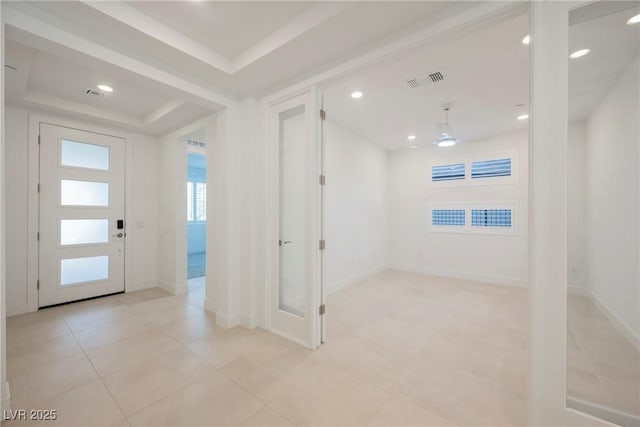entryway featuring baseboards, recessed lighting, visible vents, and light tile patterned floors