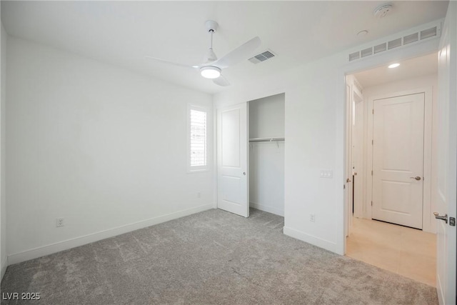 unfurnished bedroom featuring baseboards, visible vents, carpet floors, and a closet