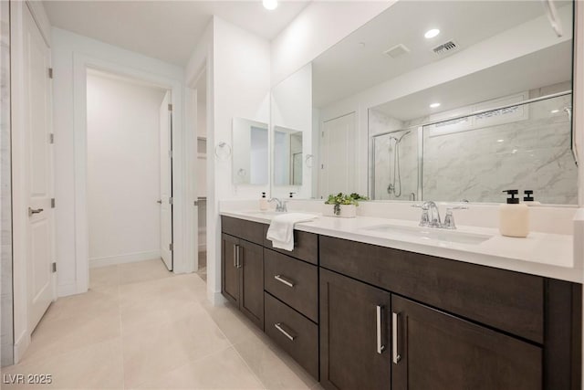full bathroom with double vanity, visible vents, a marble finish shower, and a sink