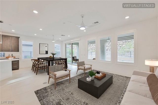 living room featuring ceiling fan, recessed lighting, and plenty of natural light
