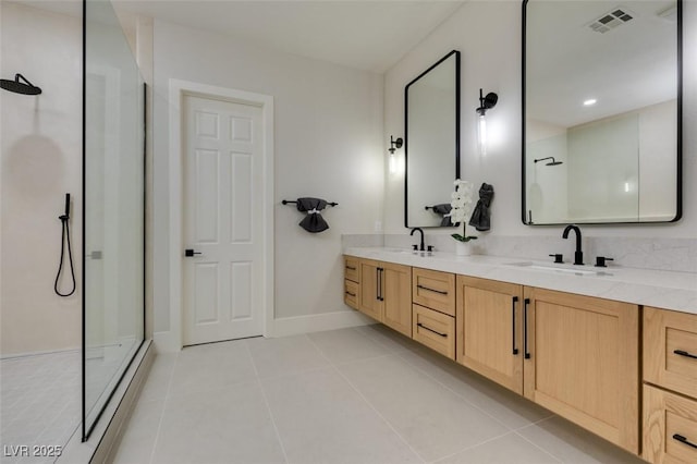 bathroom with tile patterned flooring, double vanity, visible vents, a sink, and walk in shower