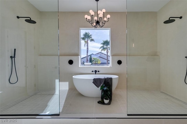 bathroom featuring walk in shower, a soaking tub, tile patterned flooring, and an inviting chandelier