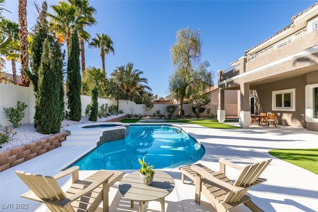 view of swimming pool featuring a fenced backyard, a patio area, a fenced in pool, and an in ground hot tub