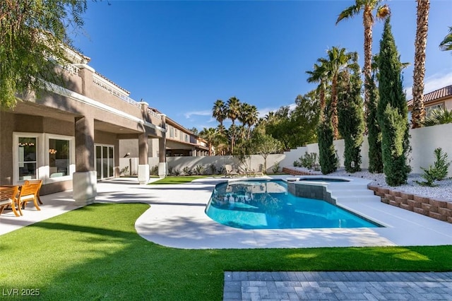 view of pool with a fenced backyard, a patio area, and a pool with connected hot tub