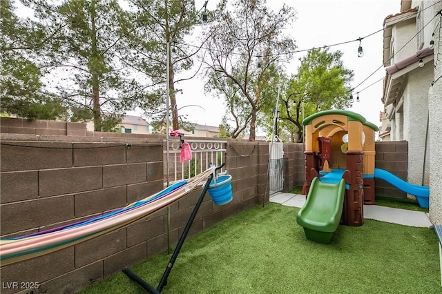 view of jungle gym with fence and a yard