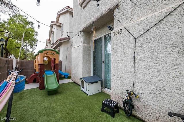 view of play area with a lawn and fence