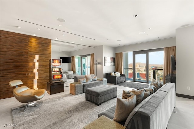 living area featuring recessed lighting and baseboards