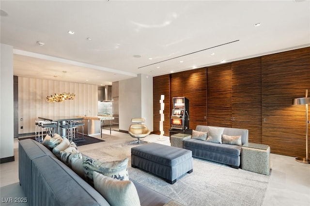 living area featuring recessed lighting and wooden walls