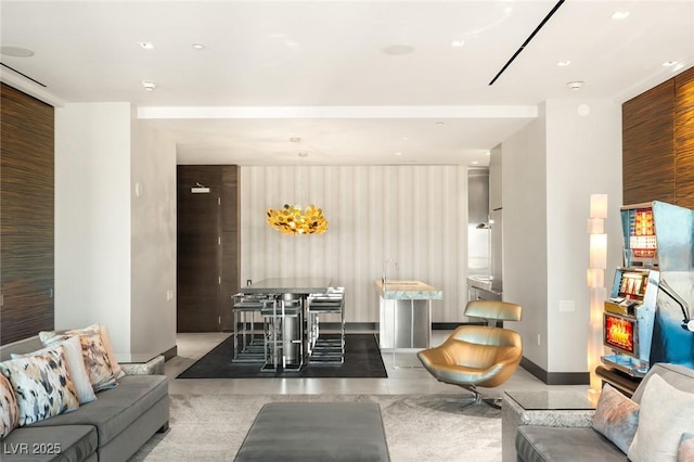 living room with recessed lighting, concrete flooring, and baseboards
