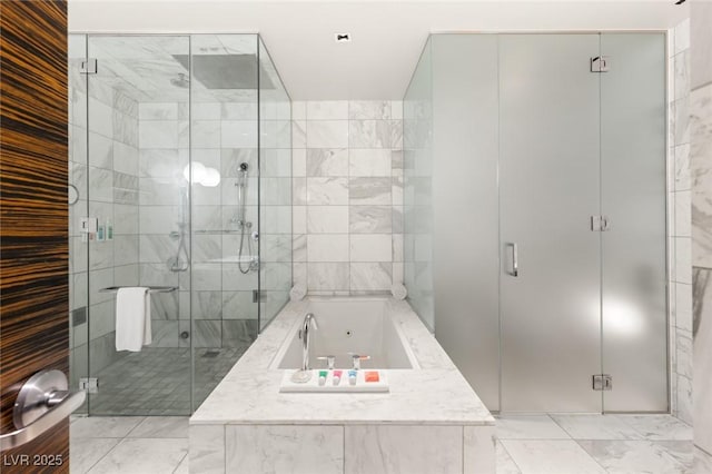 full bath with a whirlpool tub, a shower stall, and marble finish floor