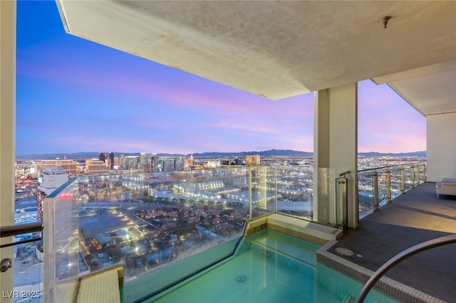 balcony at dusk with a view of city