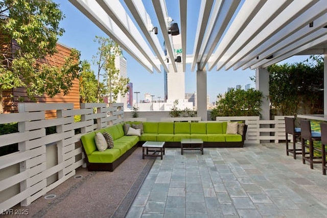 view of patio featuring an outdoor living space and fence