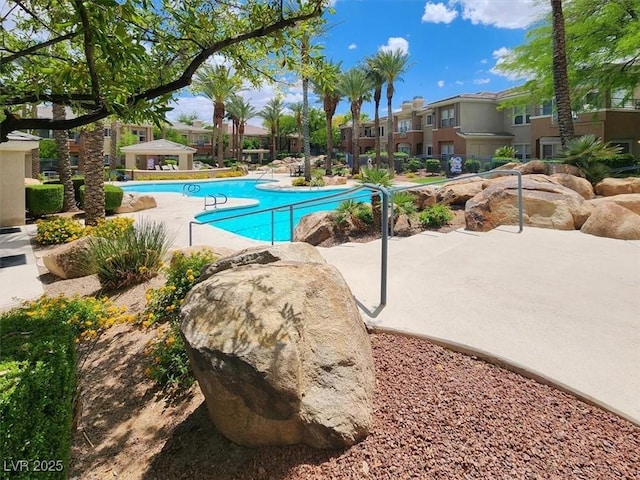 pool featuring a residential view and a patio area