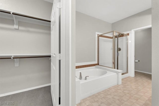 bathroom with a bath and a shower stall