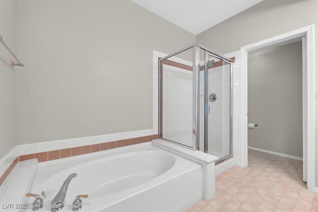 bathroom featuring a shower stall and a garden tub
