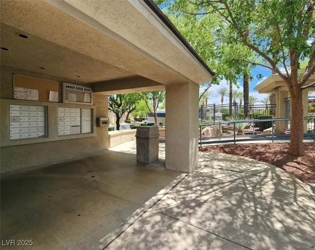 view of home's community featuring fence and mail area