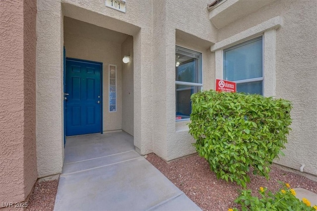 view of exterior entry featuring stucco siding