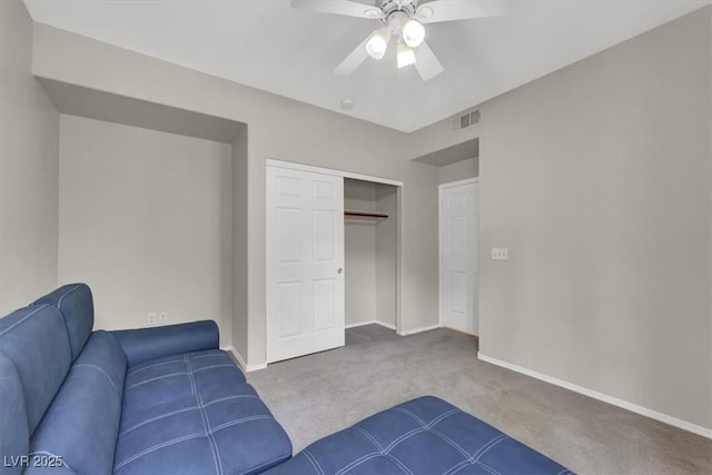 interior space featuring carpet floors, visible vents, baseboards, and ceiling fan