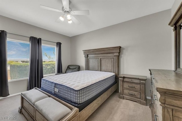 bedroom with light carpet, a ceiling fan, and baseboards