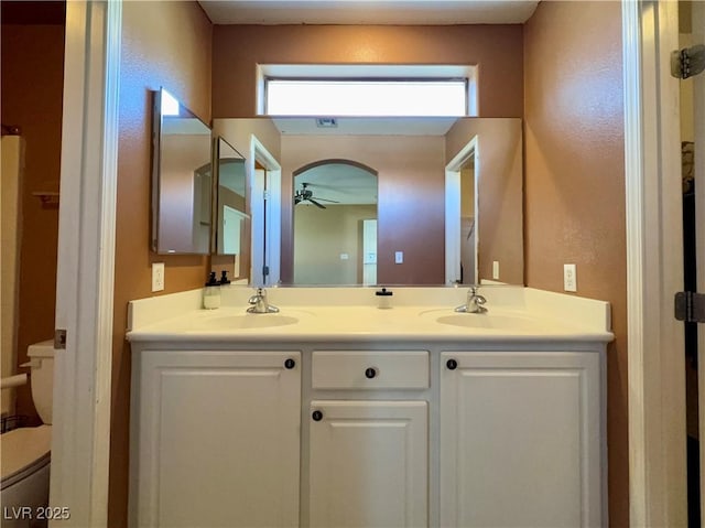 full bathroom featuring plenty of natural light, a sink, a ceiling fan, and double vanity