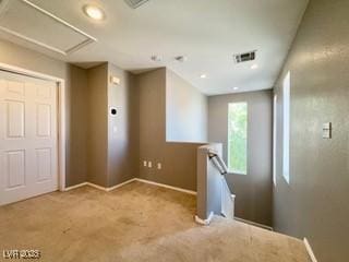 spare room featuring baseboards, carpet, recessed lighting, and visible vents