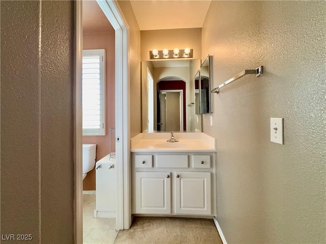 7173 Dravite Ct, Las Vegas, NV 89148 - bathroom featuring vanity, a textured wall, baseboards, and tile patterned floors