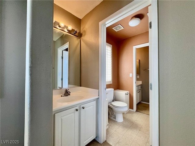 7173 Dravite Ct, Las Vegas, NV 89148 - bathroom featuring toilet, vanity, baseboards, tile patterned floors, and a textured wall