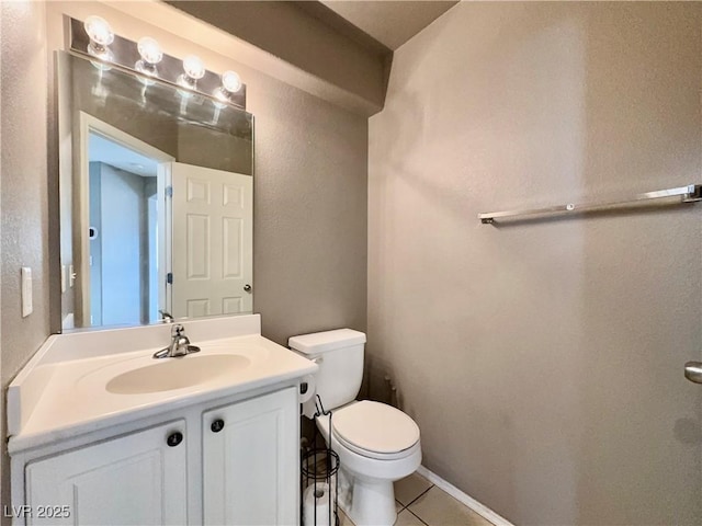 bathroom featuring toilet, tile patterned floors, and vanity