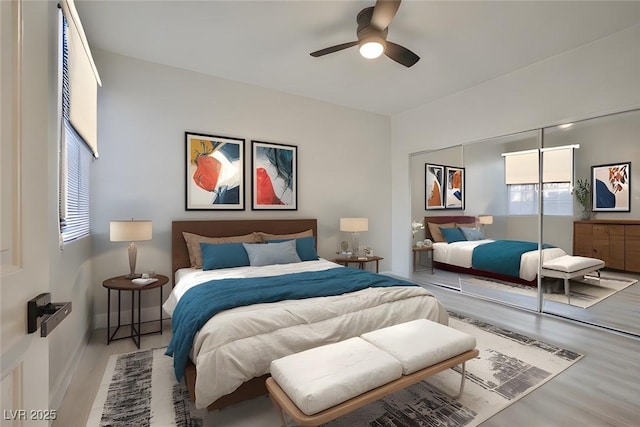bedroom featuring wood finished floors, a closet, a ceiling fan, and baseboards