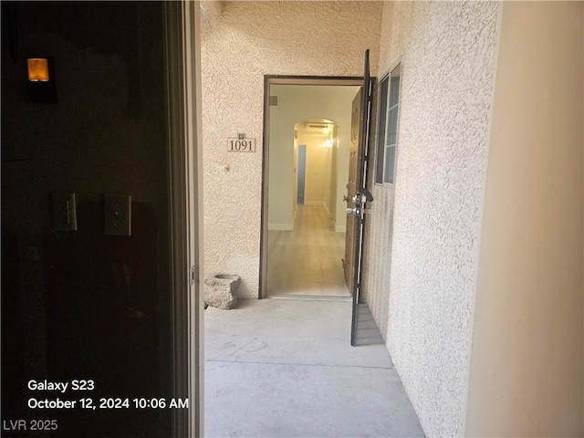 hallway featuring arched walkways