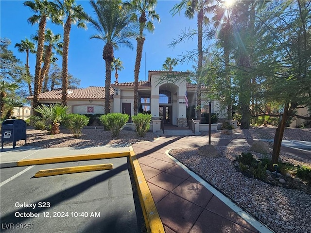 mediterranean / spanish-style house featuring a tile roof, french doors, and stucco siding