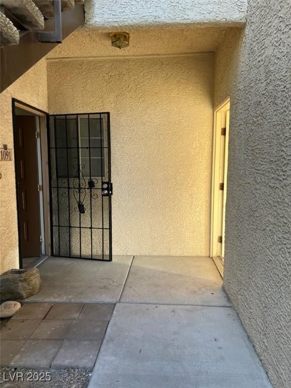 property entrance with stucco siding