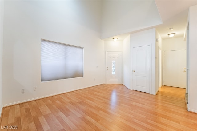 entrance foyer with light wood finished floors and baseboards