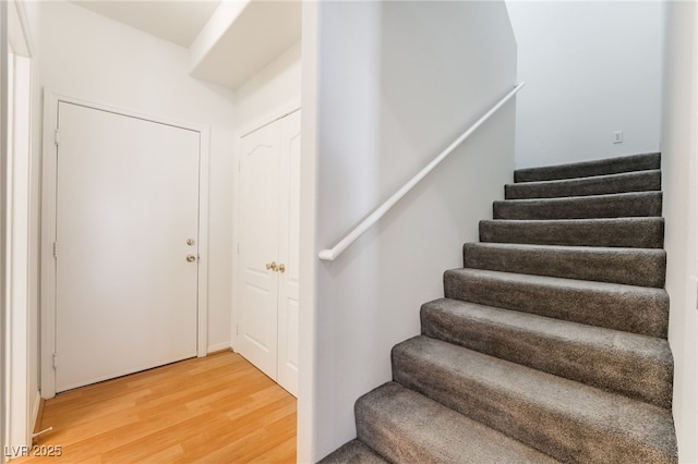 stairway featuring wood finished floors