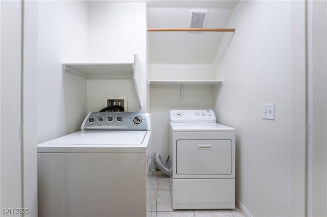 washroom featuring visible vents, independent washer and dryer, laundry area, and light tile patterned floors