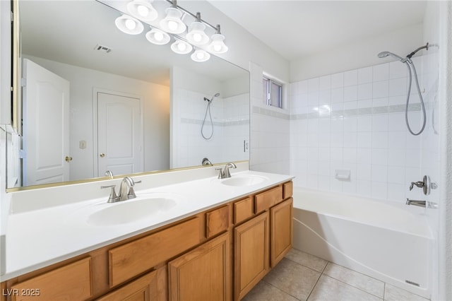 bathroom with tile patterned floors, visible vents, a sink, and tub / shower combination