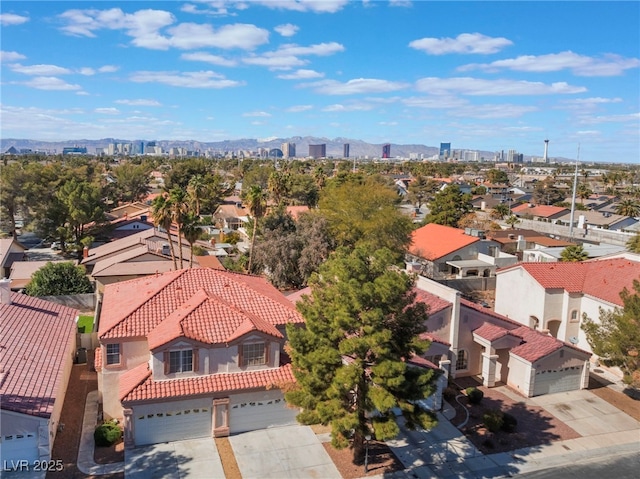 drone / aerial view featuring a residential view and a mountain view